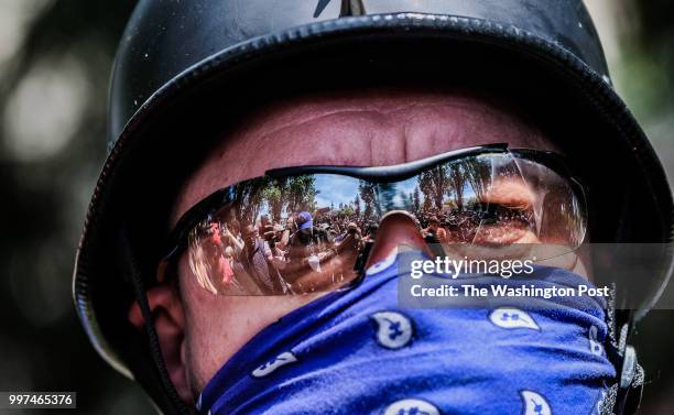 Protesters are reflected in a man's glasses at the site of a free speech protest in Civic Center Park in downtown Berkeley. The group gathered in the...