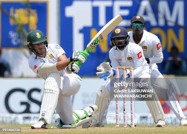 South Africa's captain Faf du Plessis plays a shot in front of Sri Lanka's wicketkeeper Niroshan Dickwella during the second day of the opening Test...