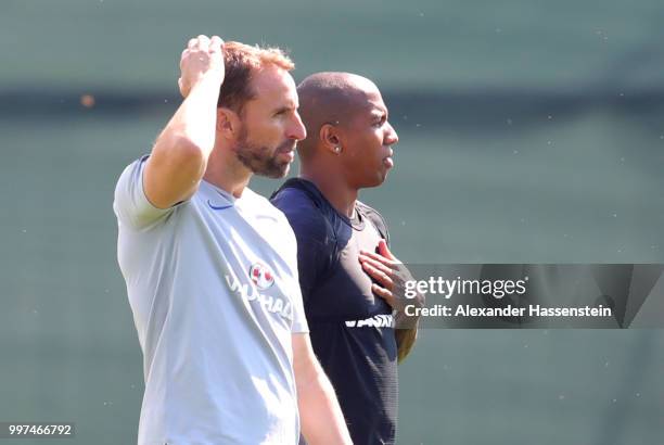 Gareth Southgate, Manager of England and Ashley Young of England look on during an England training session during the 2018 FIFA World Cup Russia at...