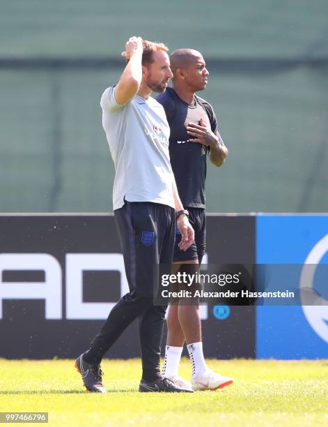 Gareth Southgate, Manager of England and Ashley Young of England look on during an England training session during the 2018 FIFA World Cup Russia at...