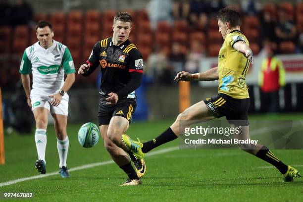 Chiefs Alex Nankivell kicks the ball ahead of the Hurricanes' Beauden Barrett during the round 19 Super Rugby match between the Chiefs and the...