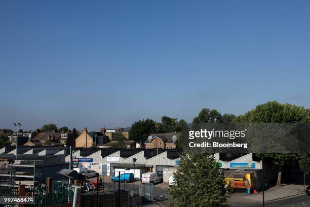The buildings of the Zennor Tradepark trading estate stand on the city skyline near residential houses in the Balham district of south London, U.K.,...