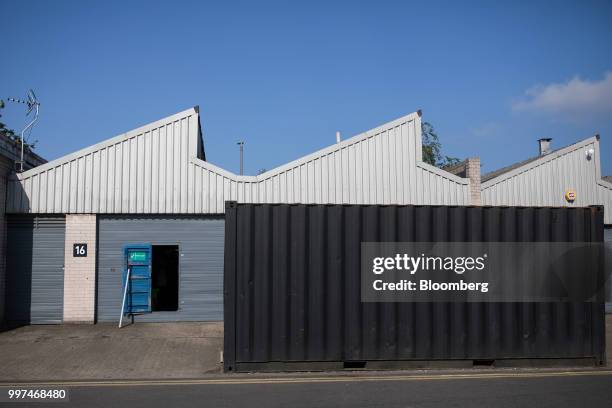 Shipping container stands outside a warehouse at the Zennor Tradepark trading estate in the Balham district of south London, U.K., on Friday, Jun....