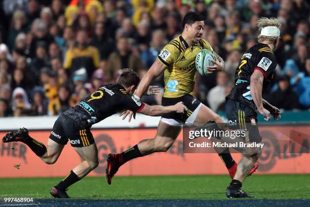 Hurricanes' Ben Lam evades the tackle from the Chiefs Brad Weber during the round 19 Super Rugby match between the Chiefs and the Hurricanes at...