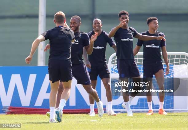 Raheem Sterling and Jordan Henderson of England take part in a drill with Ashley Young, Marcus Rashford and Jesse Lingard during an England training...