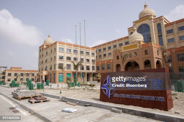 Construction materials sit next to a sign outside China Communication Construction building in the Gwadar Free Zone, operated by China Overseas Ports...