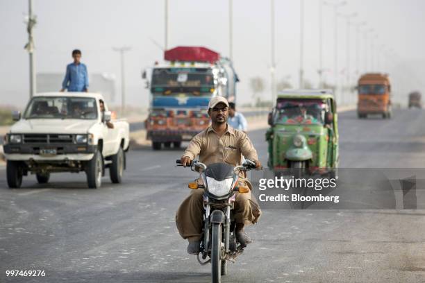 Traffic travels along a road in Gwadar, Balochistan, Pakistan, on Tuesday, July 4, 2018. What used to be a small fishing town on the southwestern...