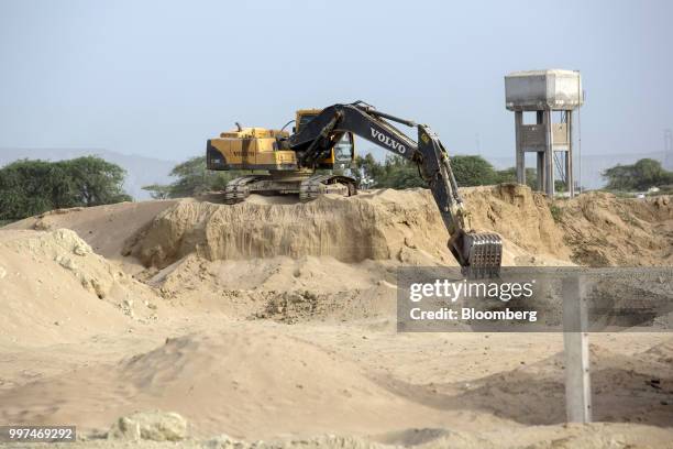 Volvo Inc. Excavator operates at a road construction site in Gwadar, Balochistan, Pakistan, on Tuesday, July 4, 2018. What used to be a small fishing...