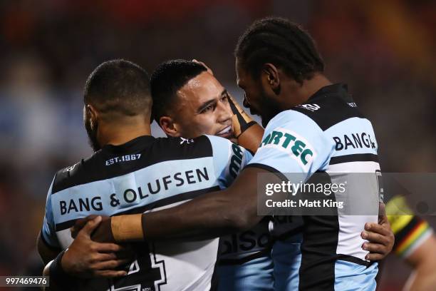 Valentine Holmes of the Sharks celebrates with team mates after scoring a try during the round 18 NRL match between the Panthers and the Sharks at...