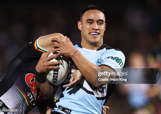 Valentine Holmes of the Sharks is tackled during the round 18 NRL match between the Panthers and the Sharks at Panthers Stadium on July 13, 2018 in...