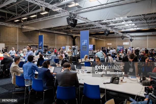 Journalists work in the media center during the North Atlantic Treaty Organization summit at the military and political alliance's headquarters in...