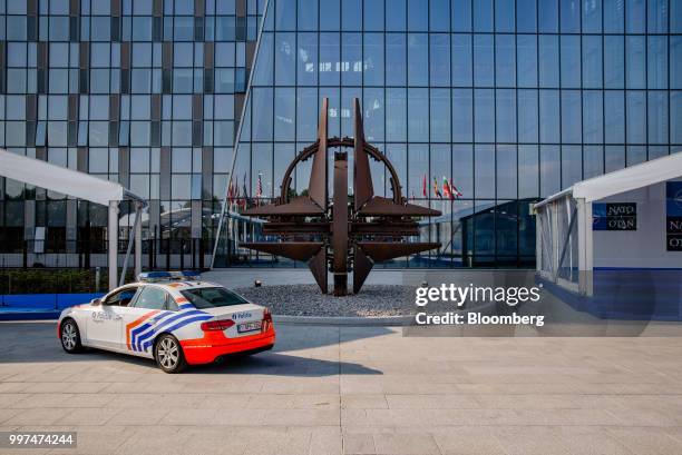 Police car stands parked in front of the NATO Star sculpture during the North Atlantic Treaty Organization summit in Brussels, Belgium, on Thursday,...