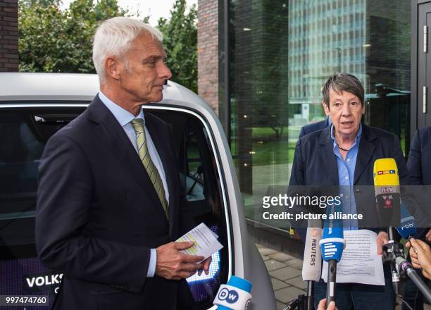 Matthias Müller, the CEO of Volkswagen AG, and German environment minister Barbara Hendricks talk to journalists outside the Volkswagen factory in...