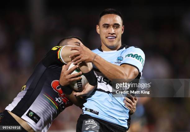 Valentine Holmes of the Sharks is tackled during the round 18 NRL match between the Panthers and the Sharks at Panthers Stadium on July 13, 2018 in...