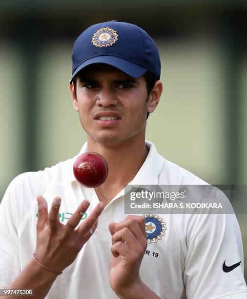 Indian under-19 cricketer Arjun Tendulkar, son of the Indian former cricket superstar Sachin Tendulkar, tosses a ball during a practice session...