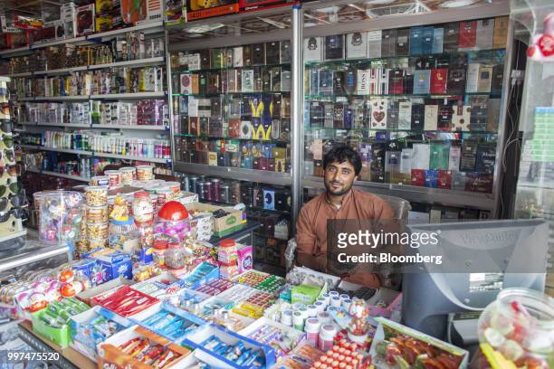 Shopkeeper sits behind a counter at the Pak China Supermarket in Gwadar, Balochistan, Pakistan, on Tuesday, July 4, 2018. What used to be a small...
