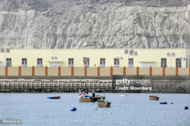 Fishermen stand on a boat outside Gwadar Port, operated by China Overseas Ports Holding Co., in Gwadar, Balochistan, Pakistan, on Tuesday, July 4,...