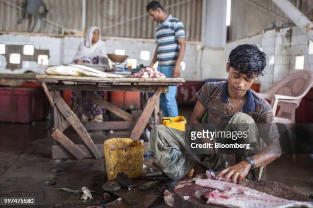 Fishmonger prepares a fish in a market at the harbor in Gwadar, Balochistan, Pakistan, on Tuesday, July 4, 2018. What used to be a small fishing town...