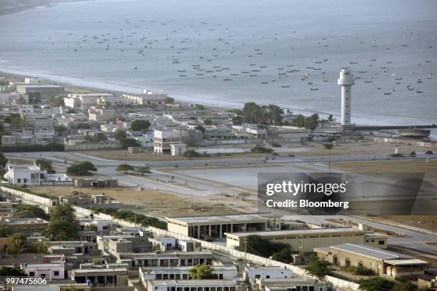 Boats sit in the Arabian Sea off the coast of Gwadar, Balochistan, Pakistan, on Tuesday, July 4, 2018. What used to be a small fishing town on the...