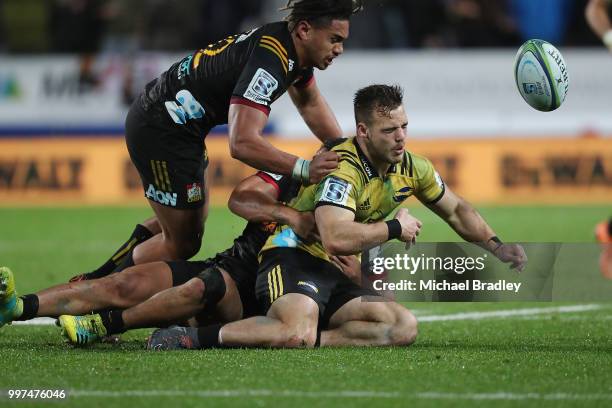 Hurricanes' Wes Goosen is tackled by Chiefs Johnny FaÕauli , who was red carrded for this tackle and Anton Lienert-Brown during the round 19 Super...