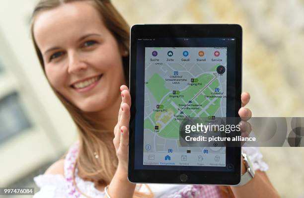 Isabelle Huber, an employee of the city of Munish, holds a tablet displaying a new Oktoberfest city app at a press conference at which the city...