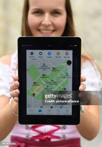 Isabelle Huber, an employee of the city of Munish, holds a tablet displaying a new Oktoberfest city app at a press conference at which the city...