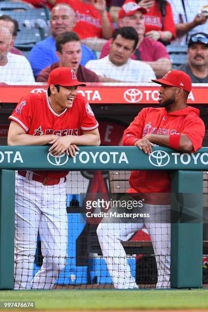 Shohei Ohtani and Luis Valbuena of the Los Angeles Angels of Anaheim smiles during the MLB game against the Seattle Mariners at Angel Stadium on July...