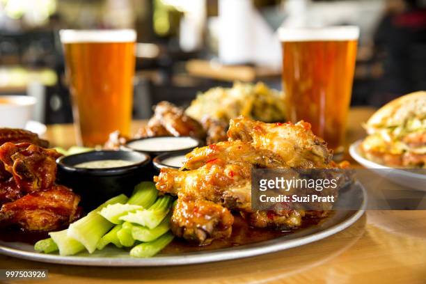 hot wings and beer - suzi pratt stock pictures, royalty-free photos & images