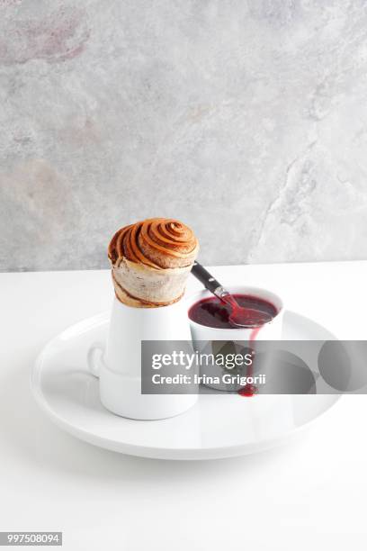 cinnamon roll and raspberry jam. - raspberry jam stock pictures, royalty-free photos & images