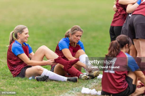 women soccer players getting ready before a game - freund stock pictures, royalty-free photos & images