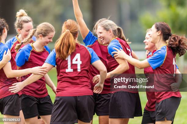 happy winning womens soccer players celebrating - david freund stockfoto's en -beelden