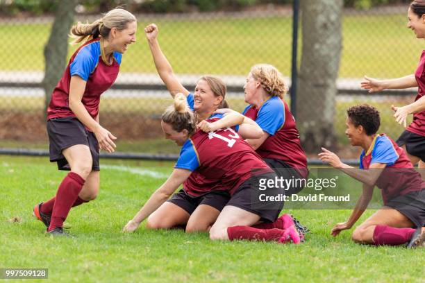 happy winning womens soccer players celebrating - freund stock pictures, royalty-free photos & images