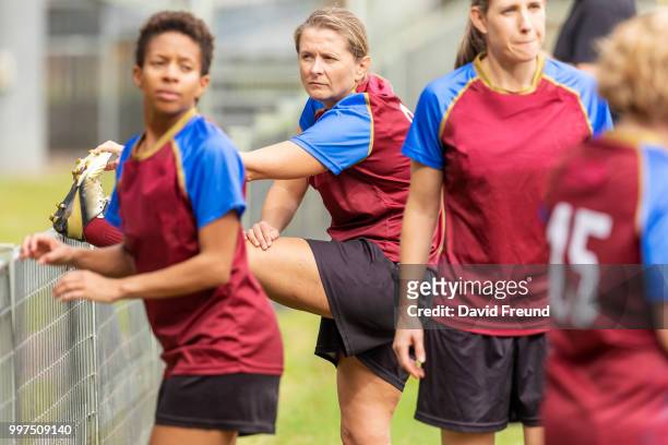 women soccer players getting ready before a game - freund stock pictures, royalty-free photos & images
