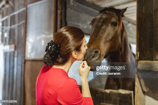 lady jockey affectionate with horse - grace tame stock pictures, royalty-free photos & images