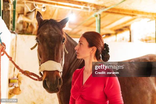 lady jockey by the tied horse - grace tame stock pictures, royalty-free photos & images