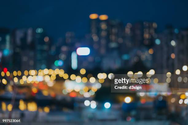 colourful defocused lights of city skyline at night - street light imagens e fotografias de stock
