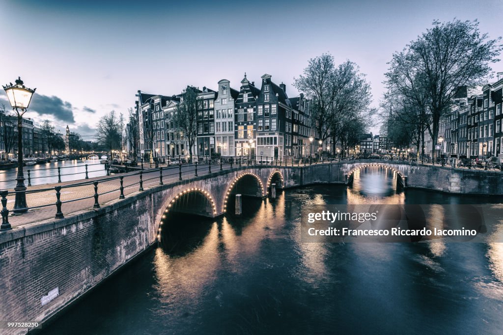 An illuminated bridge in Amsterdam, Netherlands.
