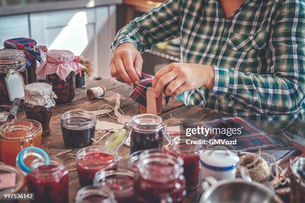 preparing homemade strawberry, blueberry and raspberry jam and canning in jars - gmvozd stock pictures, royalty-free photos & images