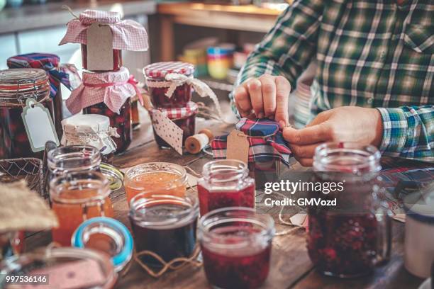 preparing homemade strawberry, blueberry and raspberry jam and canning in jars - raspberry jam stock pictures, royalty-free photos & images