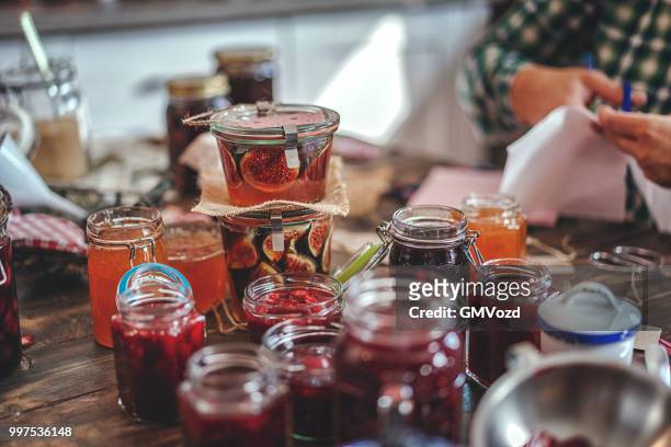 voorbereiding van zelfgemaakte aardbei, bosbes en frambozenjam en canning in potten - preserves stockfoto's en -beelden