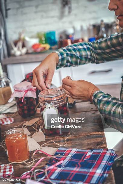 preparing homemade strawberry, blueberry and raspberry jam and canning in jars - raspberry jam stock pictures, royalty-free photos & images