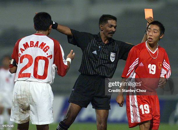 Tran Anh Tuan of Vietnam is shown the red card by the Referee as Bambang Pamungkas of Indonesia looks on in a Group B match held at the MPPJ Stadium,...