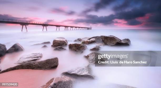 rocks in the beach - badalona stock pictures, royalty-free photos & images