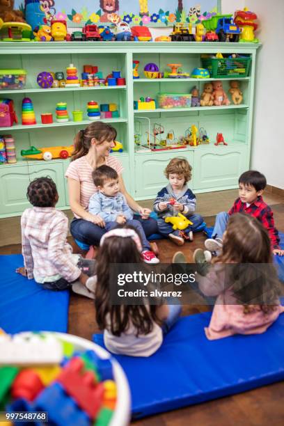 teacher telling story to preschool students - narrating stock pictures, royalty-free photos & images