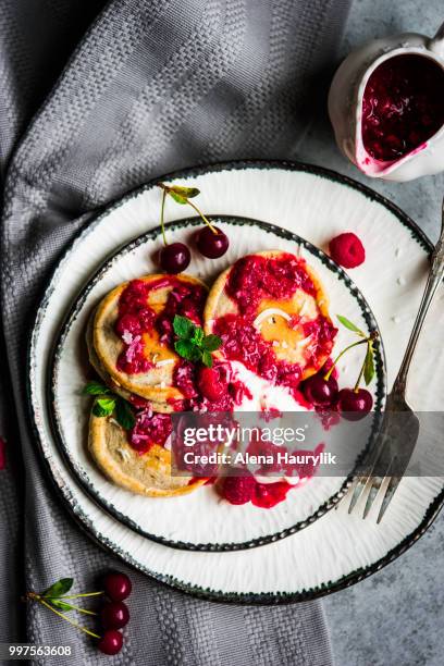 pancakes with yogurt and raspberry sauce. - raspberry sauce stock pictures, royalty-free photos & images