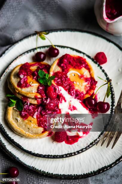 pancakes with yogurt and raspberry sauce on rustic background - raspberry sauce stock pictures, royalty-free photos & images