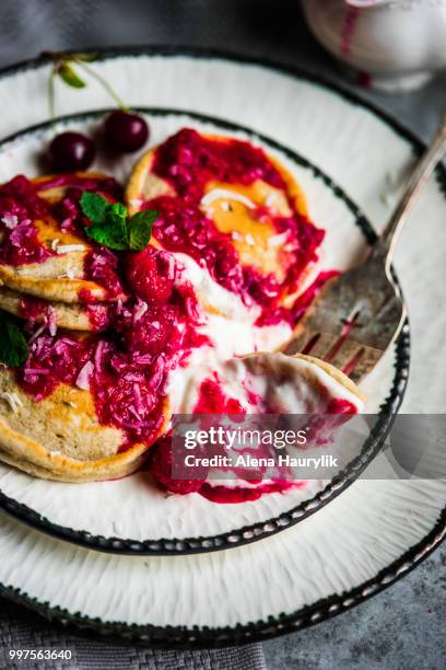 pancakes with yogurt and raspberry sauce on rustic background - raspberry sauce stock pictures, royalty-free photos & images
