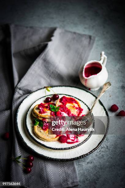 pancakes with yogurt and raspberry sauce on rustic background - raspberry sauce stock pictures, royalty-free photos & images