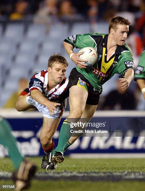 Michael Robertson of the Raiders evades a Roosters defender during the NRL first division NRL qualifying final between the Canberra Raiders and the...