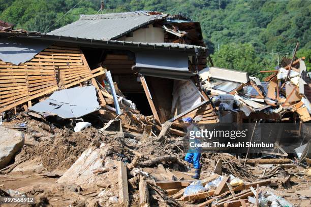 Man walks in the rubble on July 13, 2018 in Hiroshima, Japan. The death toll from the torrential rain in western Japan due to landslides, flooding...